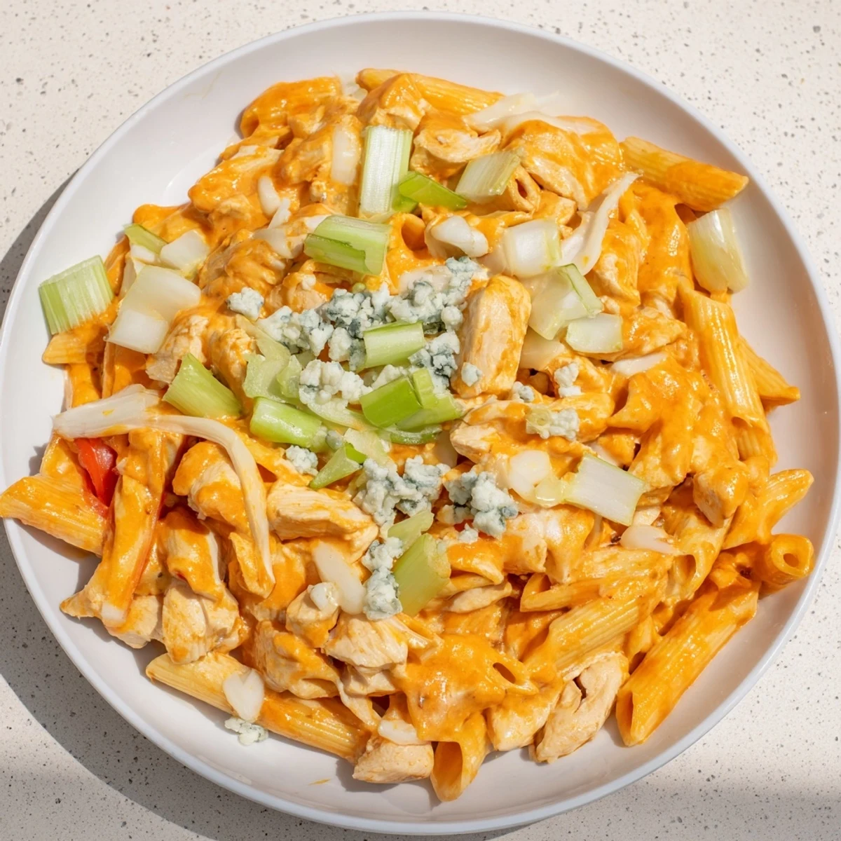 Creamy, cheesy Buffalo Chicken Pasta Skillet, a one-pan wonder bubbling with melted mozzarella.