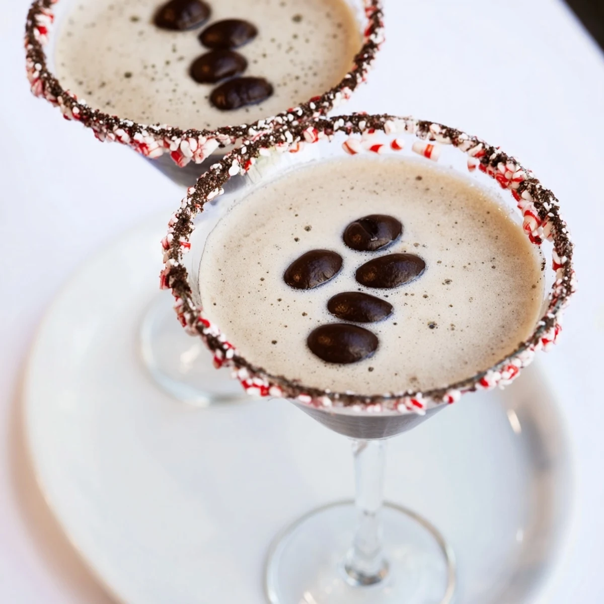 Silky Peppermint Espresso Martinis served in sugared glasses, an elegant holiday cocktail.