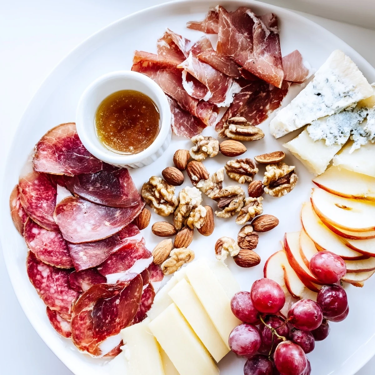 The impressive Majestic Venison Charcuterie Platter is perfectly arranged with cured venison, nuts, and jams for serving.
