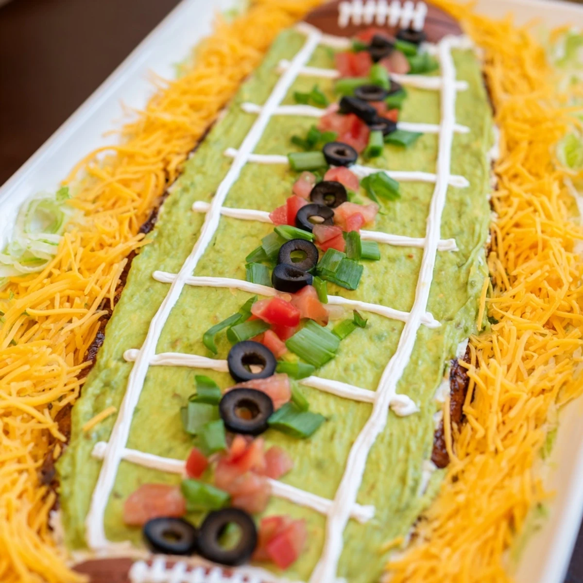 Imagine the creamy textures of this Football Field Dip, complete with toppings for a savory game day snack.