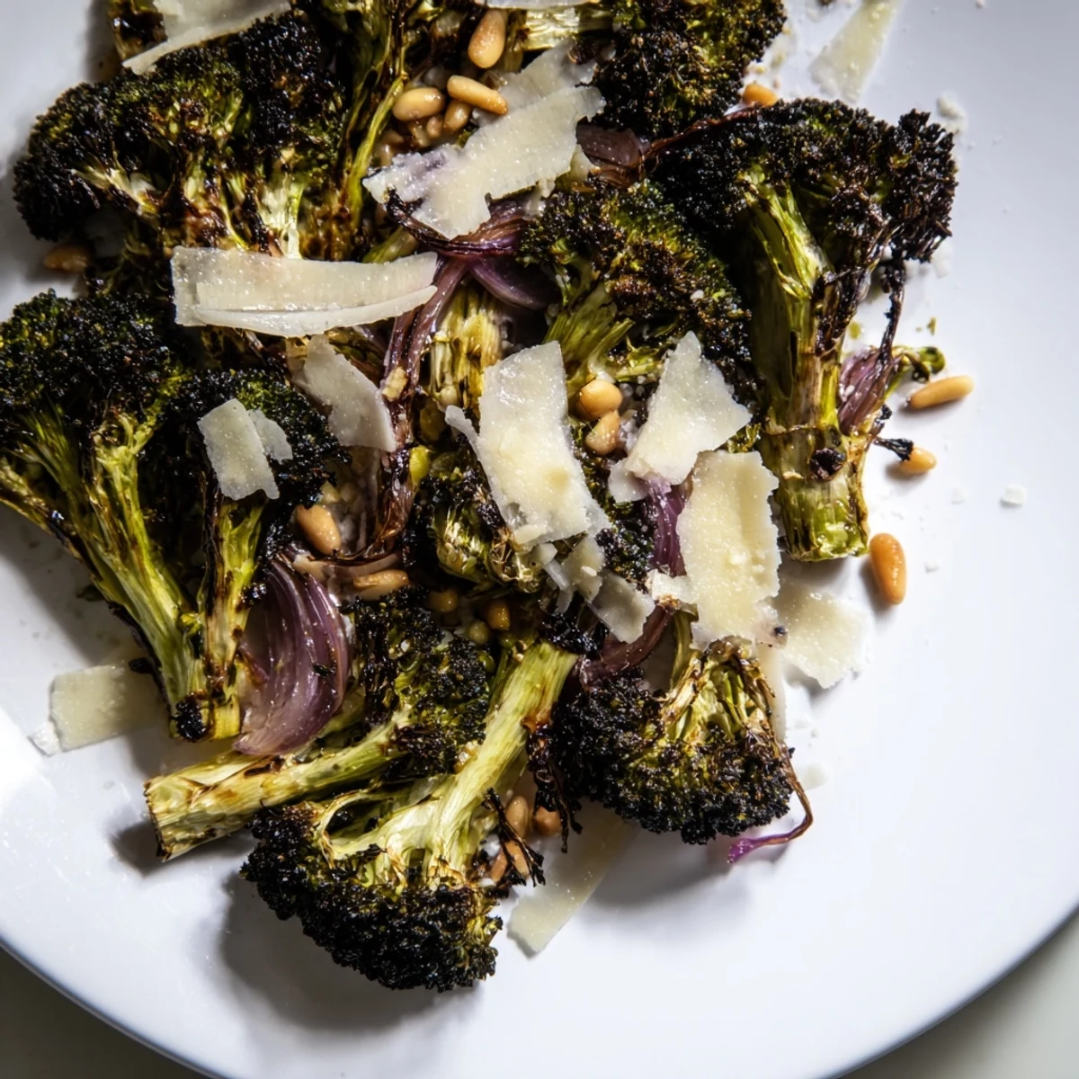 Freshly assembled charred broccoli salad sprinkled with Parmesan and ready to serve.
