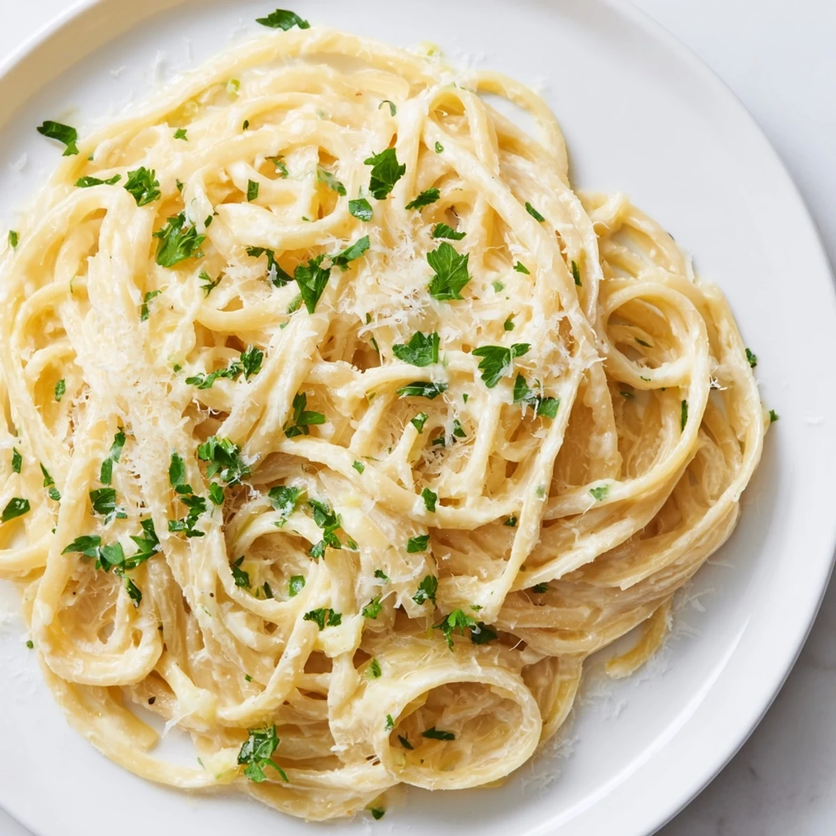 Creamy Pasta Alfredo Cottage Hack, made with smooth cheese sauce and fresh parsley garnish.