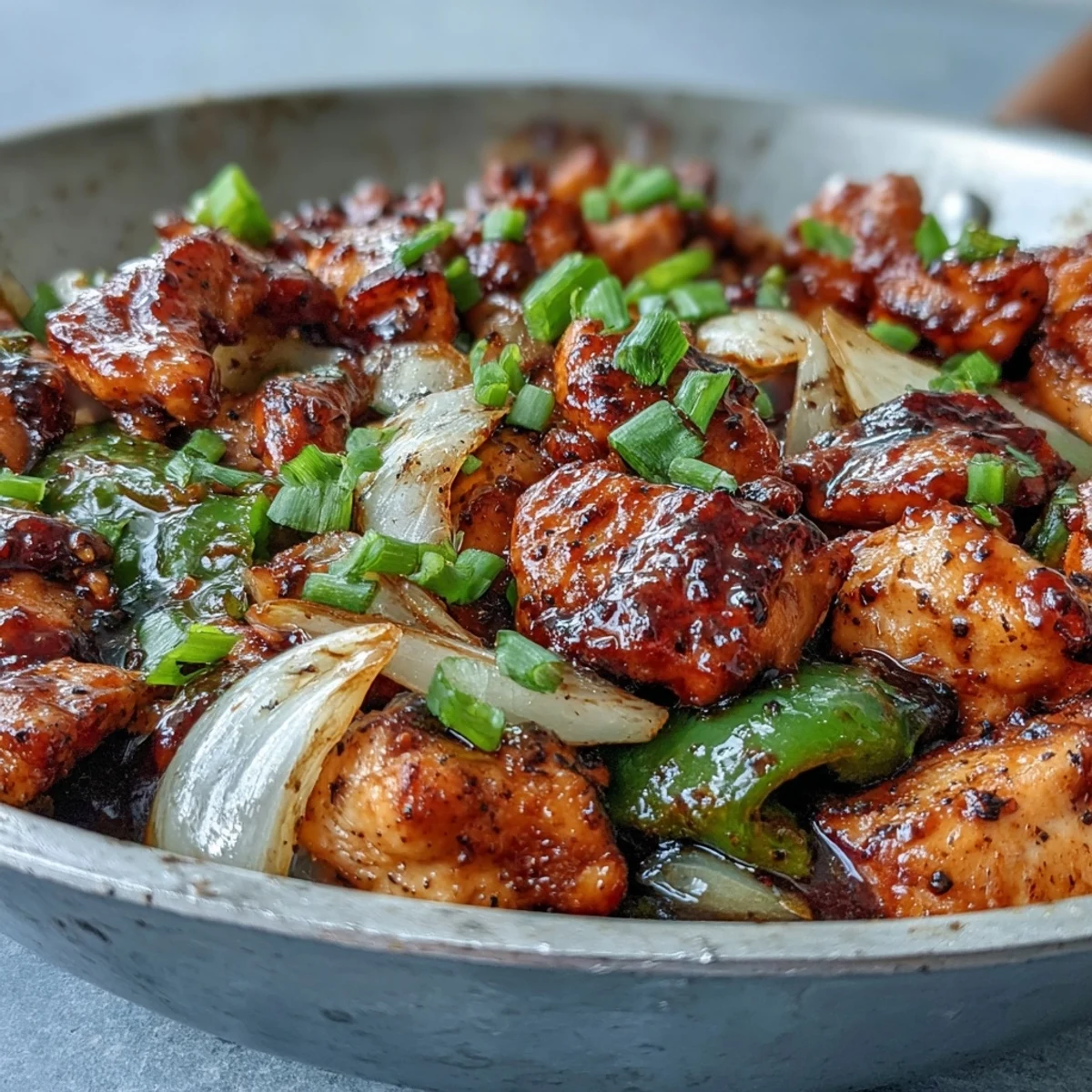 The steaming stir-fry features Black Pepper Chicken with tender chunks and vibrant green bell peppers in a glossy sauce.