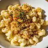 Creamy truffle macaroni & cheese is baked until bubbly, topped with crunchy breadcrumbs, ready to eat.