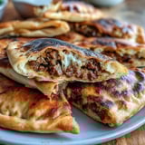 Crispy Lebanese Arayes: golden pita stuffed with spiced meat, grilled to perfection for a savory appetizer.  