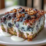 Wholesome blueberry oatmeal bake with Greek yogurt swirl, golden and bubbling with juicy berries and crunchy nuts.