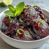 A frosty swirl of easy Frozen Grape Lime Sorbet, bursting with refreshing citrus flavor.