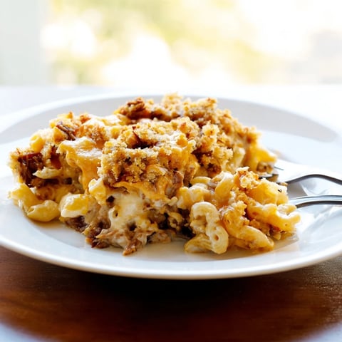 Creamy barbecue pulled pork mac and cheese, topped with golden, bubbly breadcrumbs for a comforting main dish.