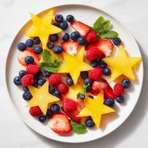 Brightly arranged starfruit and berry platter, a colorful and healthy snack for everyone.