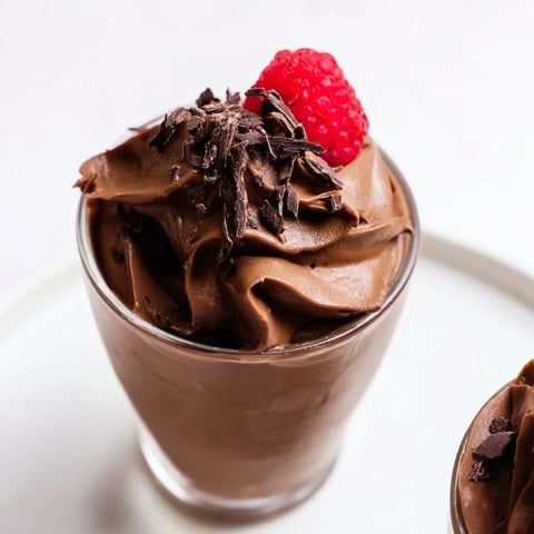 Elegant chocolate mousse dessert cups, garnished with fresh berries, ready for a special occasion.
