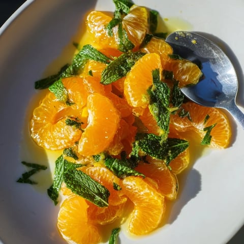 Vibrant clementine and mint winter fruit salad, bursting with citrus flavor, ready to enjoy.