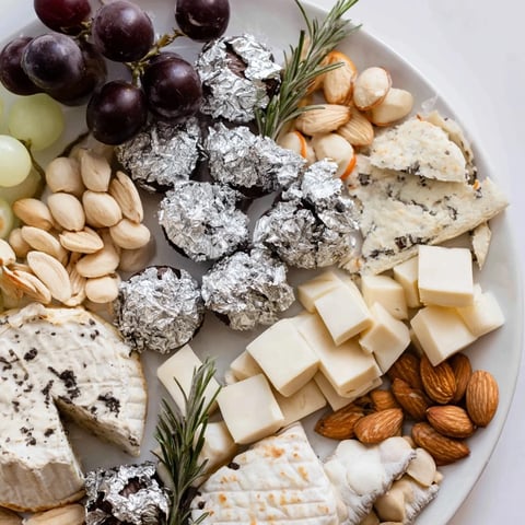 Elegant Silver Screen appetizer featuring truffle brie and silver-wrapped chocolates, ready to serve.