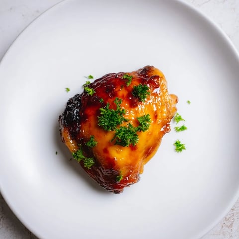 Jam in Coffee Glazed Chicken, glistening and golden, baked to perfection with a sticky, sweet glaze.