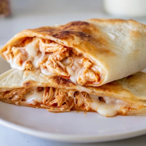 Crispy grilled Leftover Pizza Grilled Cheese with melted cheese oozing from the center.