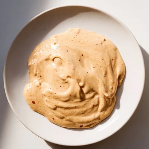 Rich Indonesian satay sauce, a creamy peanut dip, perfect for grilling vegetables and proteins.