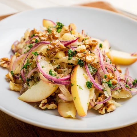 Warm Apple and Sauerkraut Skillet Salad with caramelized apples and toasted walnuts in a cast-iron pan.  