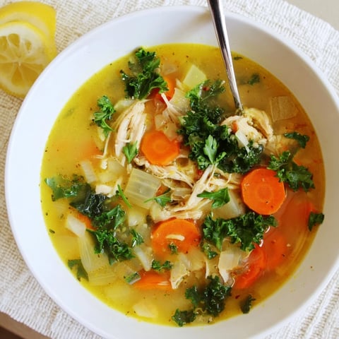 Golden turmeric and lemon zest swirl in this protein-packed chicken soup, with tender chicken and wilted baby kale floating in the rich broth.