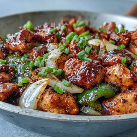 The steaming stir-fry features Black Pepper Chicken with tender chunks and vibrant green bell peppers in a glossy sauce.