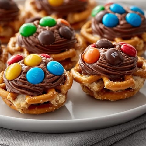 Easy Holiday Pretzel Hugs with creamy chocolate, melting slightly on salty mini pretzels.