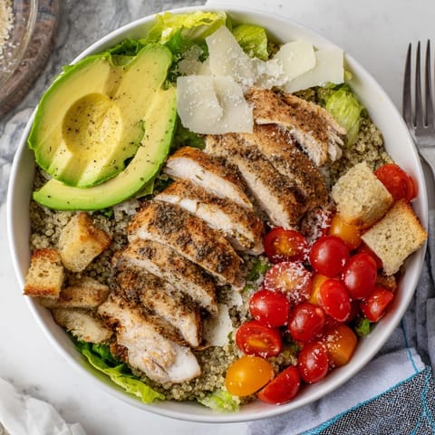 Creamy Avocado Chicken Caesar Grain Bowl: See tender chicken and fresh toppings layered invitingly.