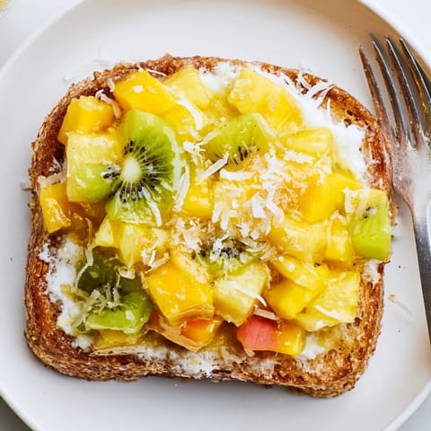 Delicious Yogurt-Custard Toast with mango, pineapple, and a drizzle of honey.  