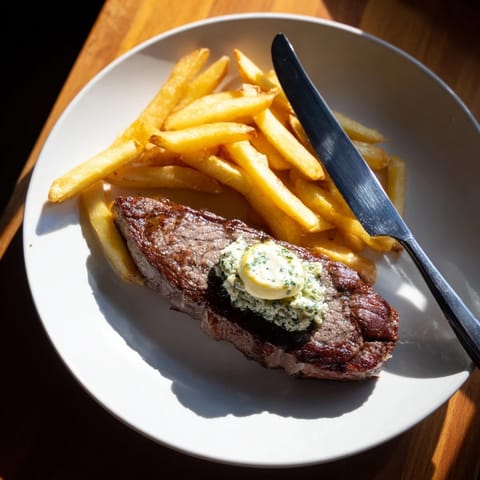 Indulgent Steakhouse Garlic Butter Steak & Fries with crispy golden potatoes and savory herbs.  