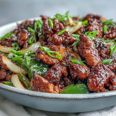 Tender marinated chicken and crisp bell peppers in a bold Black Pepper Chicken stir-fry ready to serve over rice.