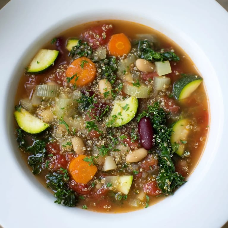 Hearty Minestrone with Quinoa, featuring vibrant vegetables and served with optional Parmesan.