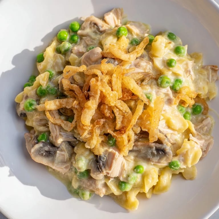 Warm and comforting, a baked dish of homemade tuna noodle casserole with a crispy onion topping.
