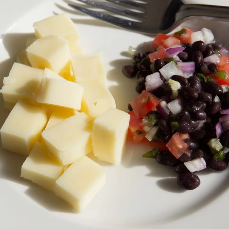 A visually appetizing platter shows spicy Pepper Jack cubes served with fresh black bean salsa.