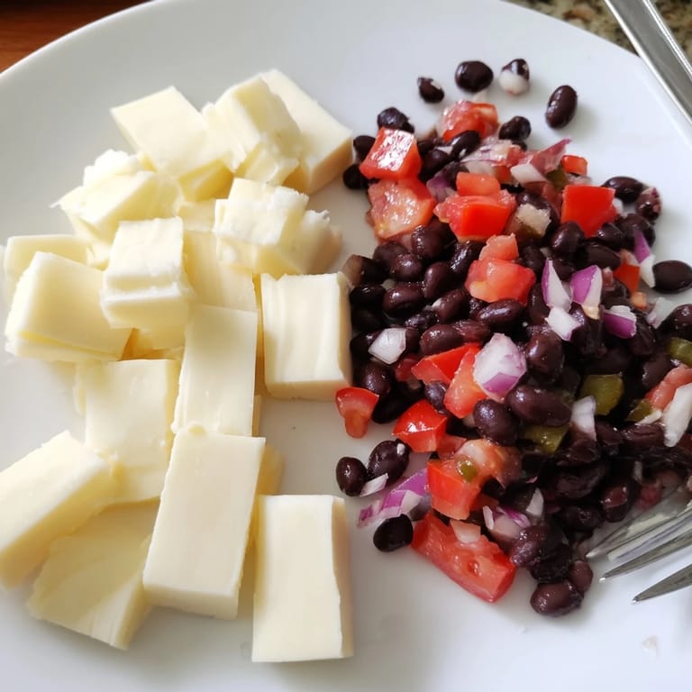 Bright red tomatoes and peppers shine in this black bean salsa, complementing Pepper Jack cheese cubes.