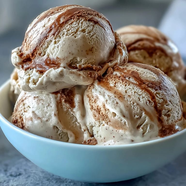Softening scoops of Hojicha Ice Cream are topped with a drizzle of sweetened condensed milk for an indulgent treat.