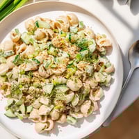 Freshly chilled Cucumber Crunch Pasta Salad in a white bowl, featuring tender shells, diced cucumbers, and everything bagel seasoning.